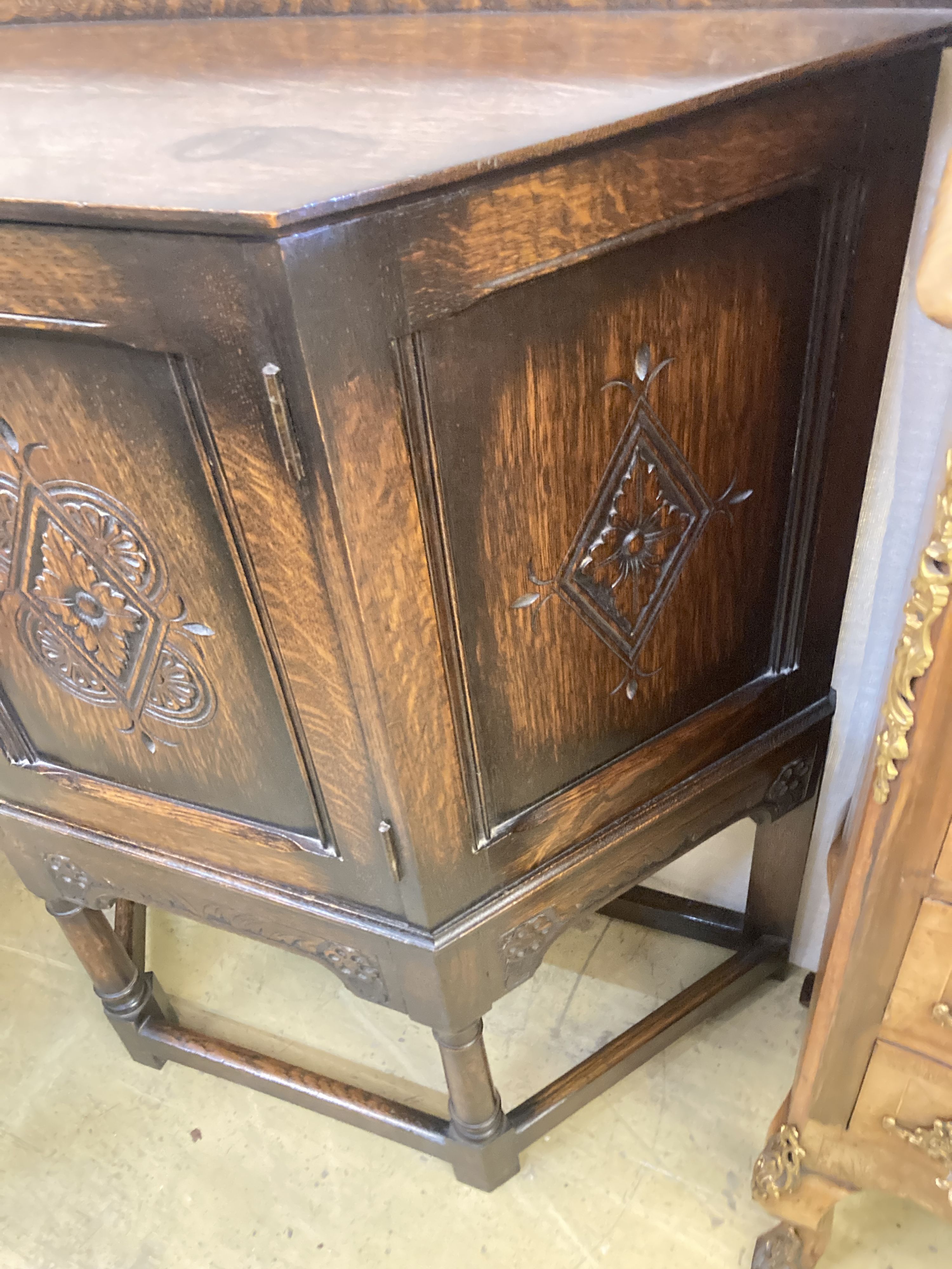 An 18th century style carved oak side cabinet, width 90cm, depth 32cm, height 88cm